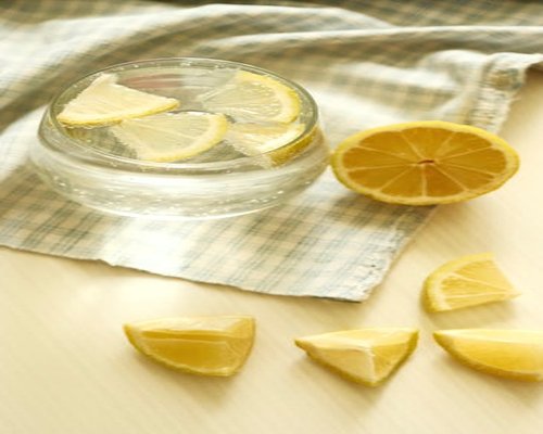 Glass of water and fresh lemon on a table